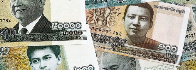 Cambodian riel money bills pile on table. Cambodia banknotes of KHR currency close up. Concept of business, economy and banking in Cambodia © mehaniq41