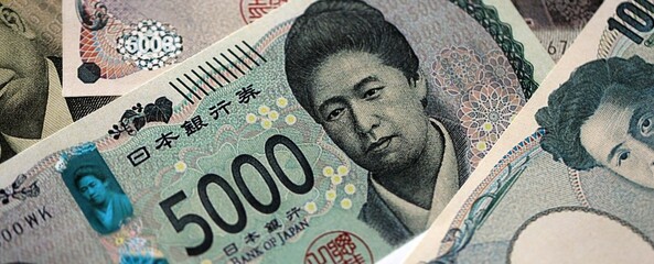 Japanese yen money bills pile on table. Japan banknotes of JPY currency close up. Concept of business, economy and banking in Japan © mehaniq41