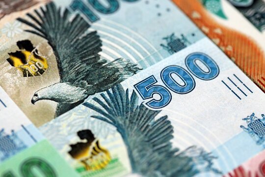 Zambian kwacha money bills pile on table. Zambia banknotes of ZMW currency close up. Concept of business, economy and banking in Zambia