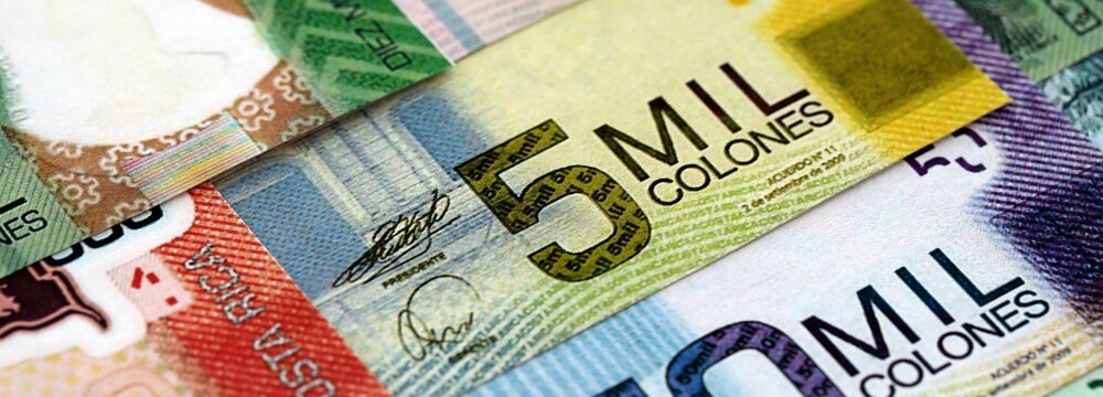 Costa Rican old and new colon money bills pile on table. Costa Rica banknotes of CRC currency close up. Concept of business, economy and banking in Costa Rica