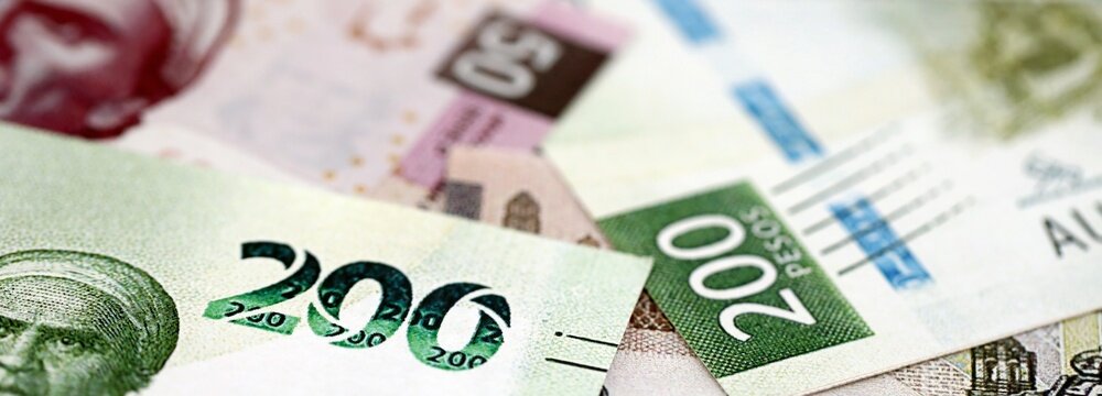 Mexican peso money bills pile on table. Mexico banknotes of MXN currency close up. Concept of business, economy and banking in Mexico