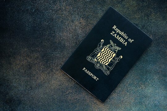 Zambian passport on table close up. Official identification document book for citizens of Zambia. Concept of travel and tourism in Zambia