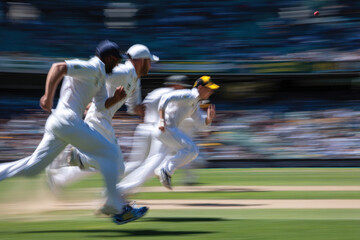 A focused group of cricket players run energetically across the field, embodying the thrill of competition and teamwork in this fast-paced and dynamic sport.