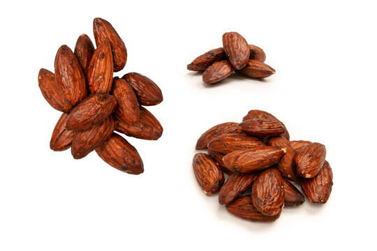 A group of caramelized almonds isolated on a white background.