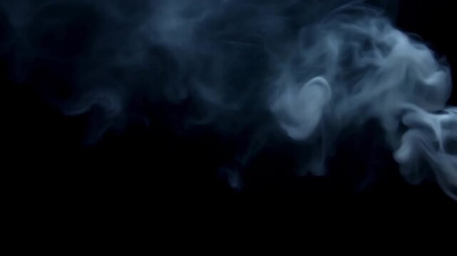 Blue smoke swirling slowly in dark space forming elegant abstract vapor patterns and mysterious atmospheric background. Concept of cinematic atmosphere and creative design