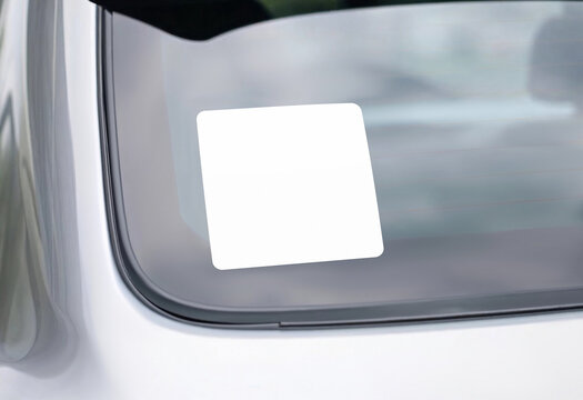 Blank white square sticker on car window, ai generated. Empty decal symbol on transport for driving care mockup, crop view. Clear adhesive banner on auto glass for babu on board icon template.
