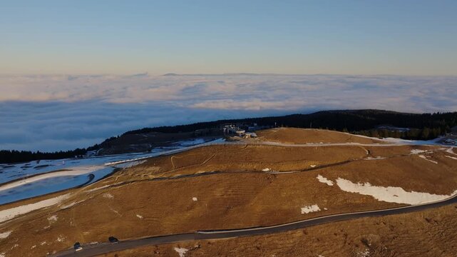 sunrise at a ski resort with a sea of clouds in the background (Semnoz, France)