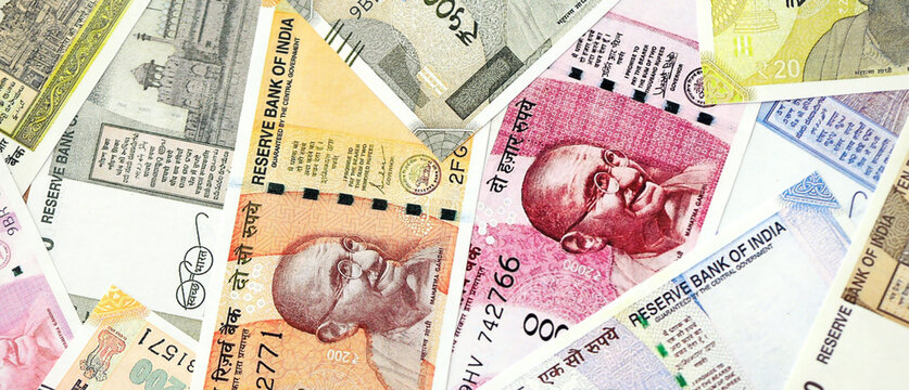 Big pile of Indian Rupees money bills banknotes close up. Lots of money of Indian INR currency cash in big bunch. Economics and business in India