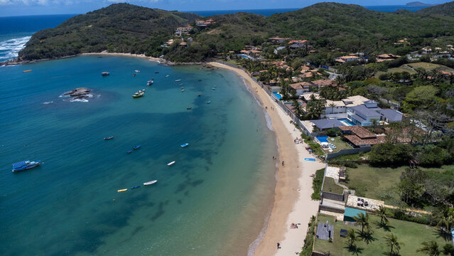 Drone view of Praia da Ferradura in B&uacute;zios Brazil on sunny day with turquoise transparent ocean &ndash; tropical beach and coastal scenery