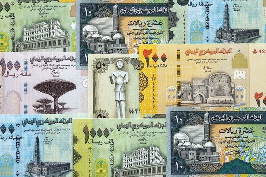 Yemeni rial paper banknotes pile on table. Yemen YER currency money bills in big amount. Concept of economics, taxation and banking in Yemen
