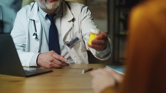 Male endocrinologist prescribing hormone pills to young woman patient, check-up