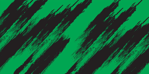 Abstract black grunge brush strokes on green background with rough paint texture. © Riyan