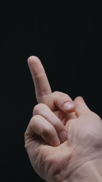 A close-up of a man hand showing the offensive middle finger gesture. Concept of anger, rebellion, protest, disrespect, and non-verbal communication.