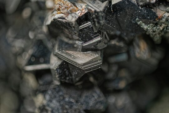 Macro photo of sphalerite crystals from the Dalnegorsk deposit in Russia showing intergrown geometric forms with metallic luster and dark coloration