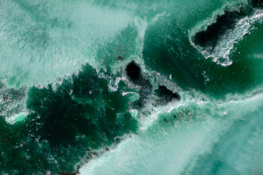 Polished malachite from Kamenushinskoe deposit, macro 4X &mdash; green waves, microcavities with microcrystals and limonite contrast. Unique natural abstraction