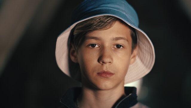 Teenage Boy Wearing Blue Bucket Hat Looking at Camera, have fun and enjoy