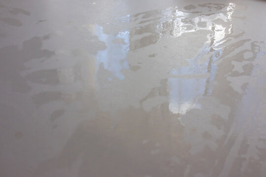 Wet table surface with water reflections
