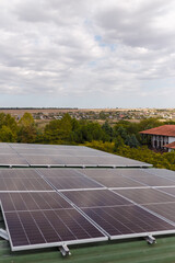 solar panels on rooftop with some trees and sky background. Renewable sunlight alternative energy, eco-friendly technology