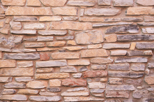 The beige sandstone brick masonry wall texture rustic old background facade