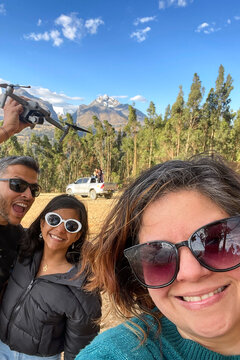 Family with drone and pickup truck in mountain landscape. UGC