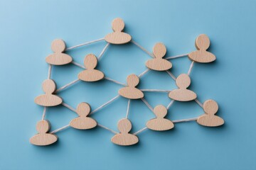 Fototapeta premium Networked Connections: A visual representation of interconnectedness, showing wooden cutouts linked together by lines, symbolizing collaboration, communication.