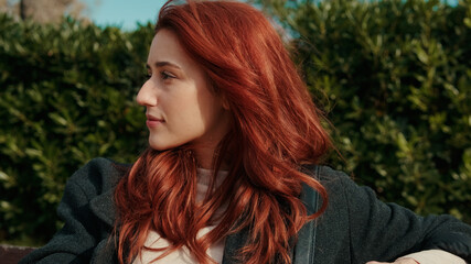 Obraz premium Red Haired Woman Outdoors in Green Garden