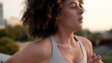 Athletic Woman Running Outdoors At Sunset