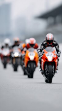 Blurred in motion: Motorcycle race with multiple riders on track with numbered helmets