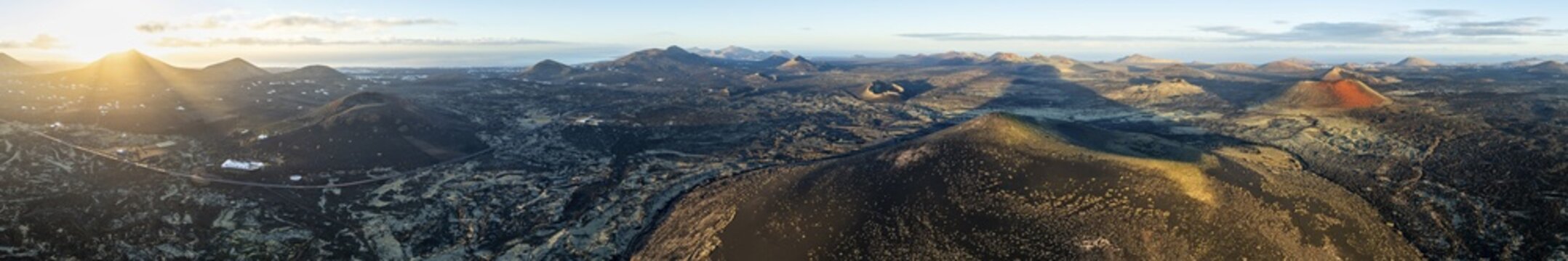 Picturesque volcanic landscape with volcanic craters and lava fields in morning light, Monta&ntilde;a Negra volcano, Caldera Colorada and Volc&aacute;n de Las Nueces, Los Volcanes Natural Park, aerial view, Lanzarote, Canary Islands, Spain