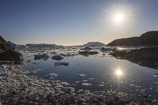 Icebergs and ice floes reflected in the water, summer, midnight sun, Jakobshavn glacier and ice fjord, Ilulissat Kangerlua, Disko Bay, West Greenland, Greenland