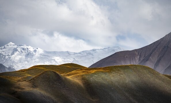 Dramatic mountain landscape, mountain valley, behind glaciated and snow-covered mountain peak Pik Lenin, Trans Alay Mountains, Pamir Mountains, Osh Province, Kyrgyzstan