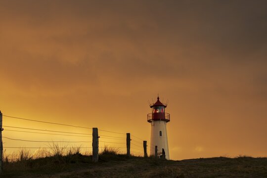 List-ost lighthouse, in dune landscape at golden hour, Ellenbogen, List, Sylt Island, Germany