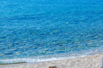 Obraz premium Beautiful view of Aegean Sea with clear blue water and gentle waves washing sandy beach. Kos. Greece.