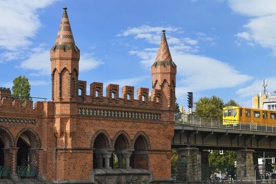 Yellow S-Bahn on Oberbaum bridge over the Spree river, Berlin, Germany