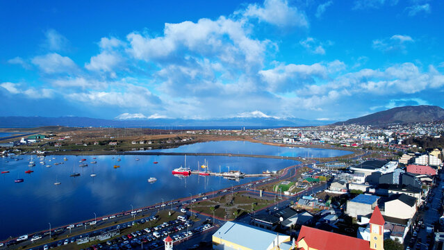 Port Of Ushuaia In Ushuaia Tierra Del Fuego Argentina. City Skyline Showing Modern And Traditional Architecture. Nature Tourism Icon Snow Covered Forest Trees. Nature High Angle View.