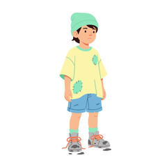Young boy standing in casual outfit with a beanie and sneakers  