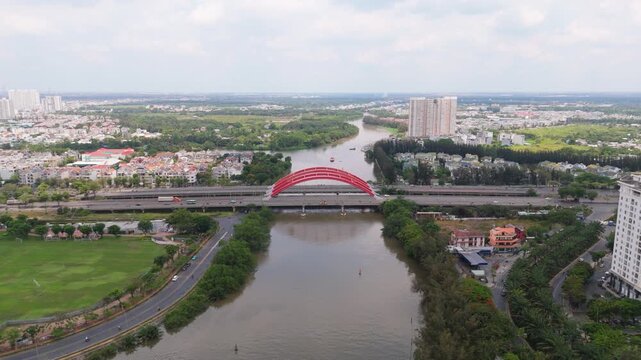 Aerial view of Ong Lon Bridge on Nguyen Van Linh Boulevard with urban traffic and canal, modern infrastructure scene in Ho Chi Minh City