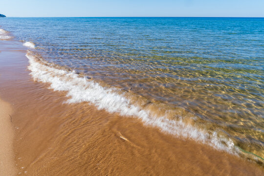 Lake Michigan wave breaking on sandy beach shore near Holland Michigan