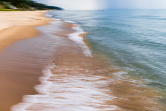 Motion blur waves along sandy Lake Michigan shoreline