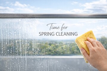 Spring cleaning theme with hand holding yellow sponge on window, background © dvoevnore