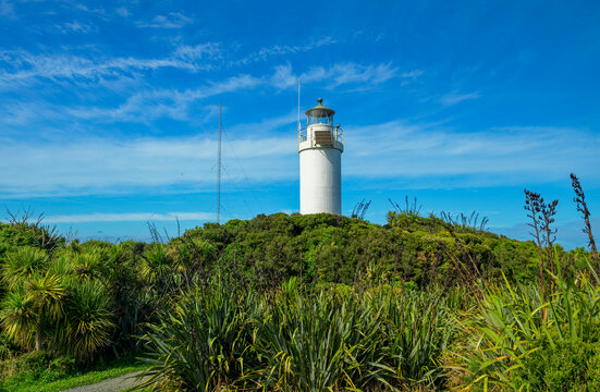 The lighthouse at Cape Foulwind, Tiritiri Matangi, stands out strikingly against the blue sky in New Zealand