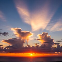Fototapeta premium Brilliant crepuscular rays pierce dramatic cloud formations during a vibrant ocean sunset
