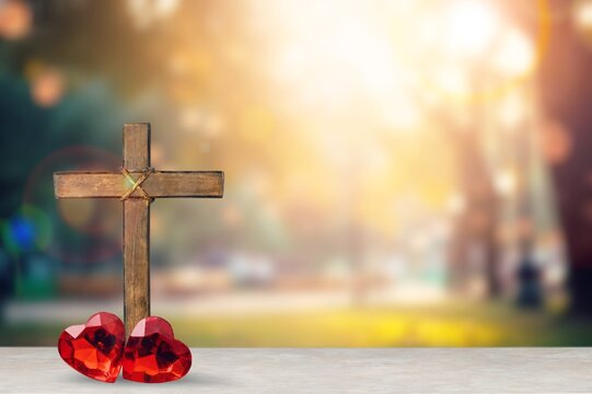 Red heart and Christian wooden cross