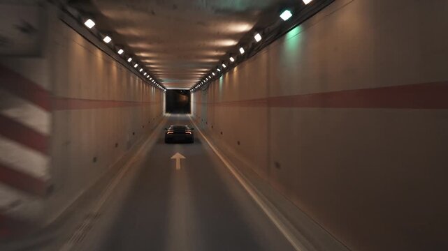 Luxury sports car driving through a modern tunnel