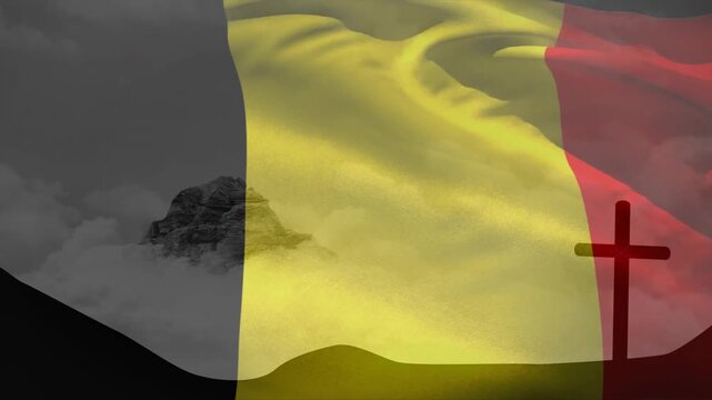 Black yellow red sheer flag starting slack by breeze, rippling, shifting opacity to reveal peak