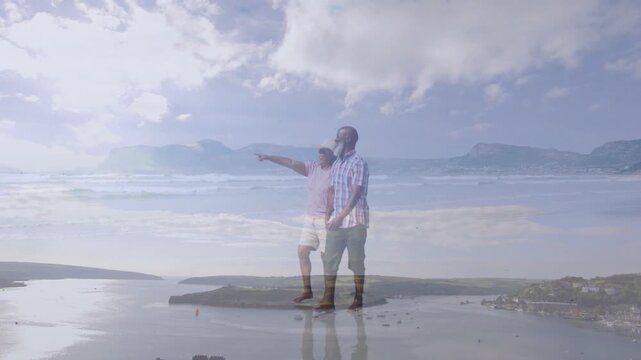 Couple pointing at horizon then walking on sandbar sun-hat passing with ghosted overlays for travel