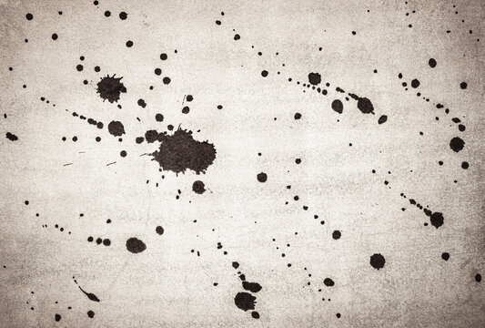 Ink splash over vintage paper, black watercolour splatter background.