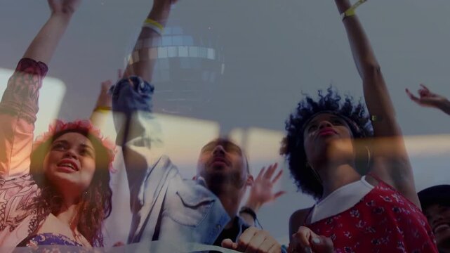 Trio at barrier singing and raising arms as music triggers disco flares sweeping across faces