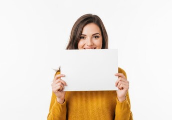 Fototapeta premium Woman holding a blank sign with a cheerful expression against a plain background