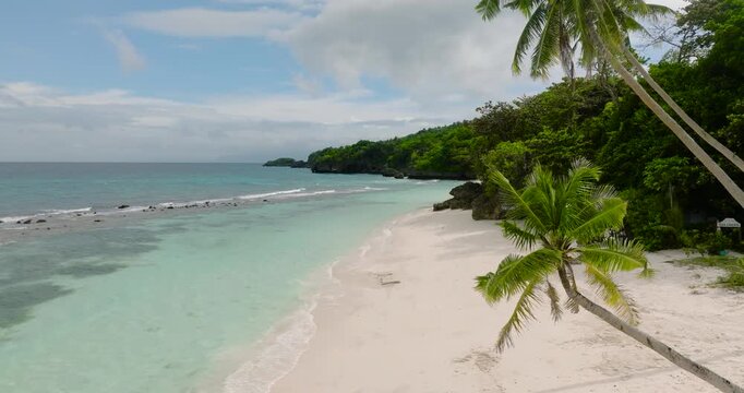 Tropical landscape of ocean waves and white sand beach. Sea Garden in Carabao Island. Romblon, Philippines.